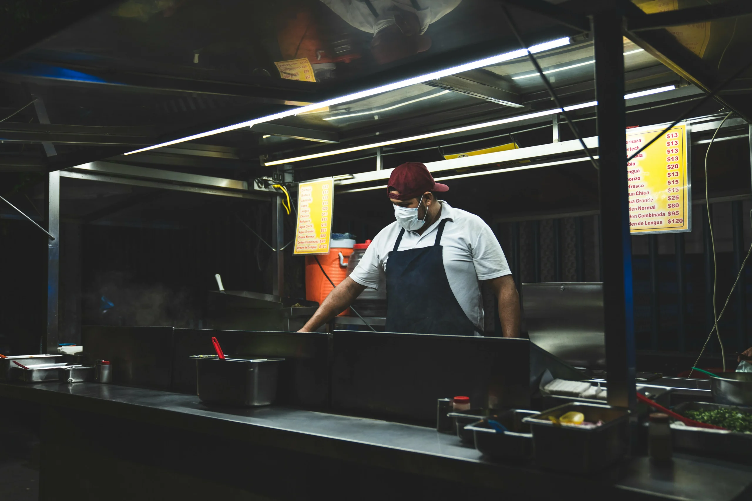 New Hampshire business owner standing beside an on-site ATM machine for customer cash withdrawals